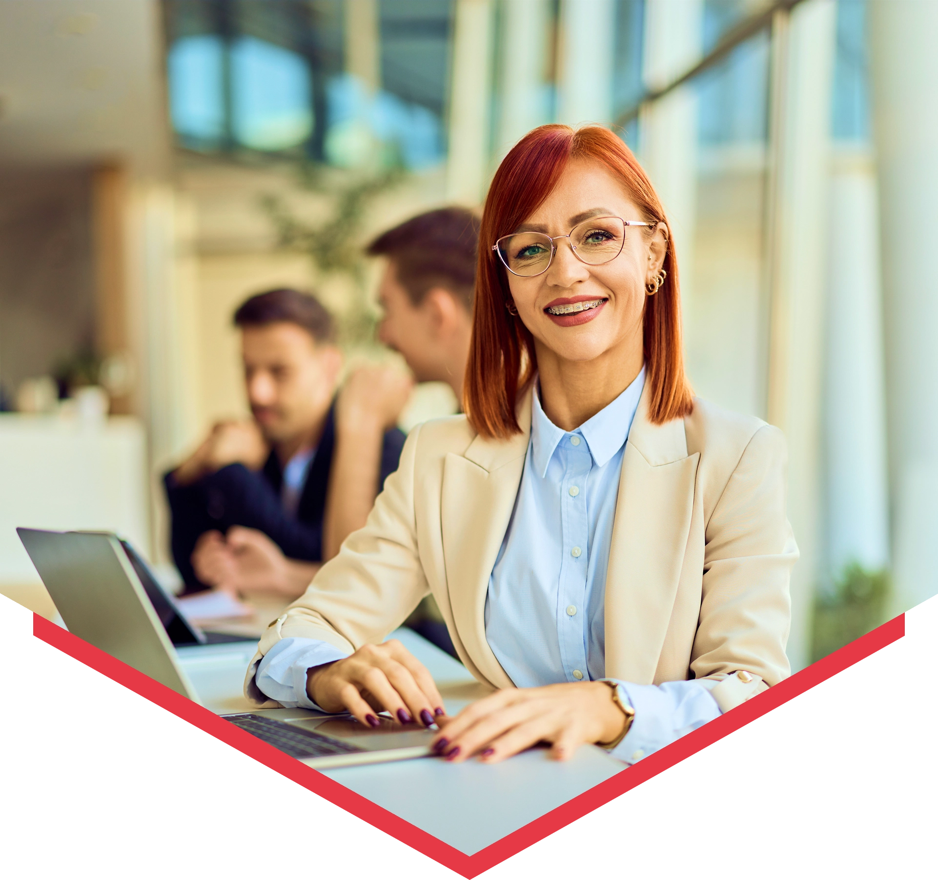 Smiling professional woman at office desk.
