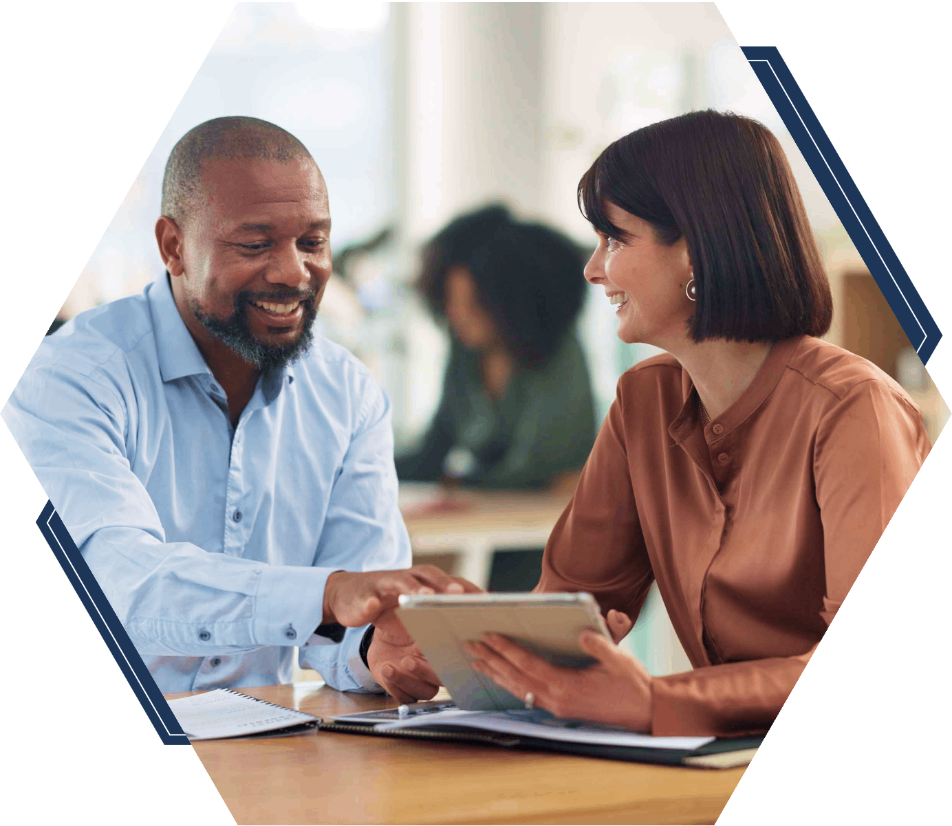 Man and woman discussing over a tablet.